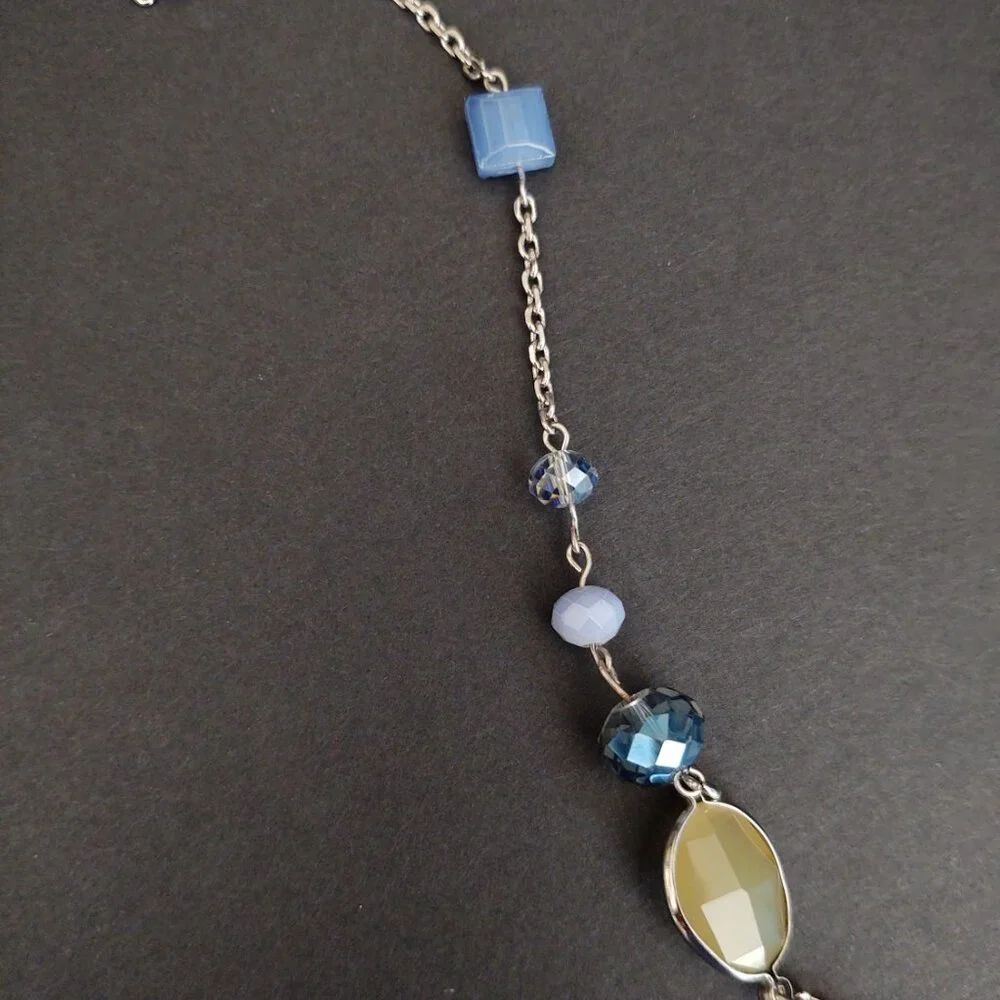 Long silver necklace with blue and yellow glass beads